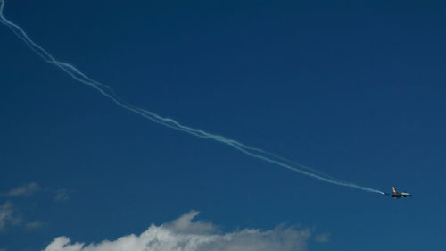 Low angle view of airplane flying in sky