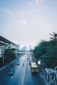 Traffic on road in city against sky