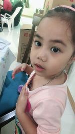 Portrait of cute girl holding camera