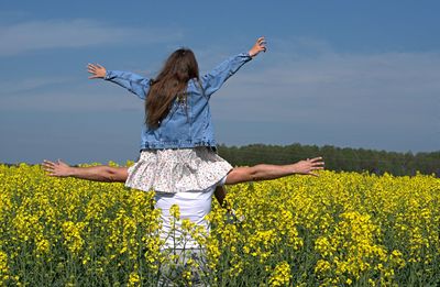 Low angle view of flowering plants on field against sky