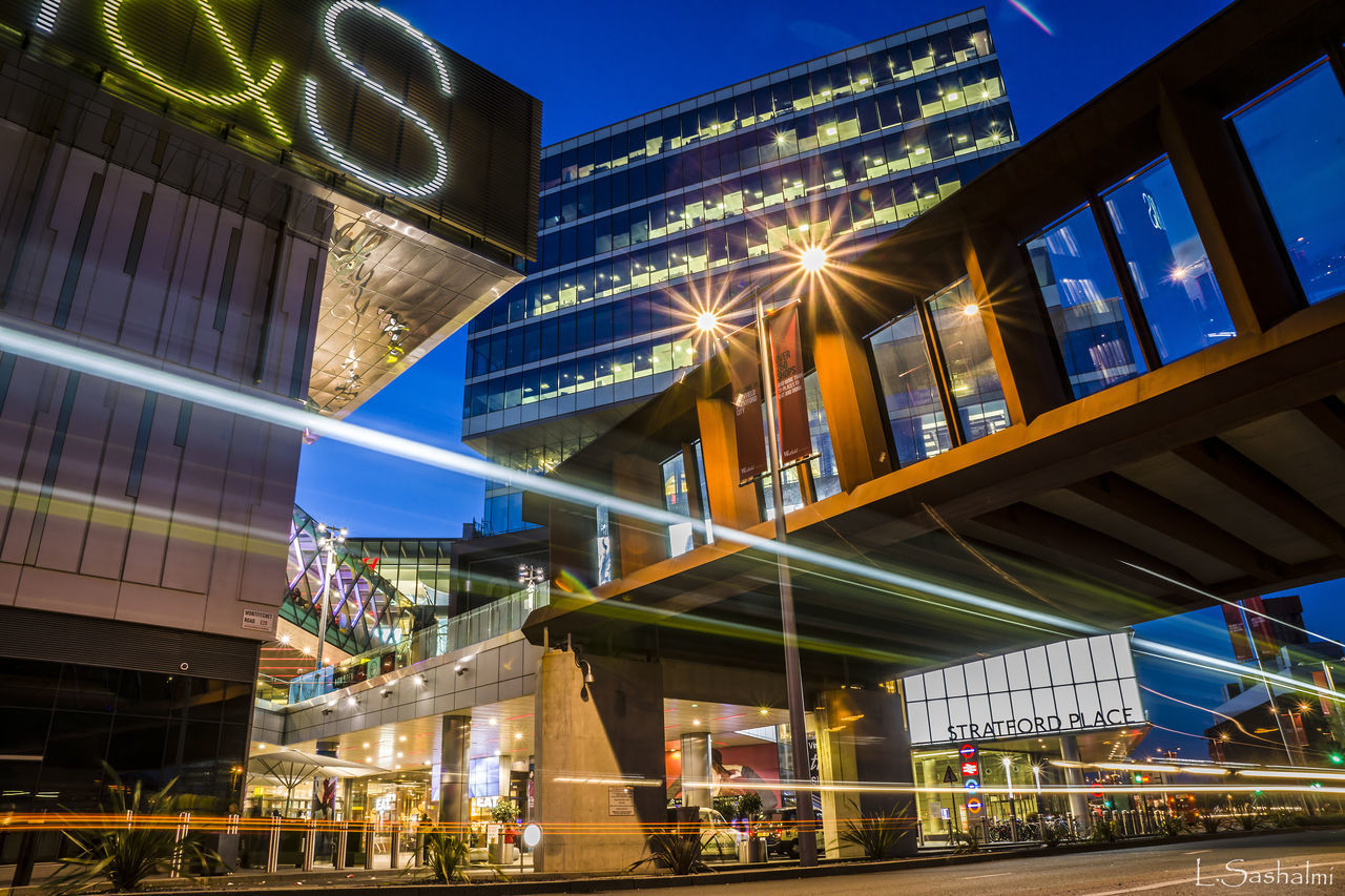 LOW ANGLE VIEW OF ILLUMINATED BUILDING AT NIGHT