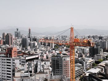 High angle view of modern buildings in city against clear sky