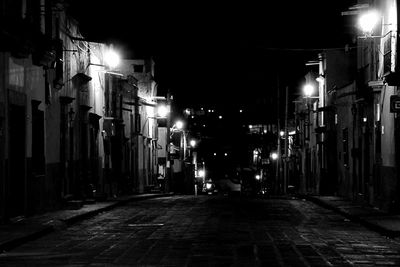 Illuminated street lights in city at night