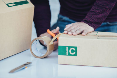 High angle view of man holding box on table