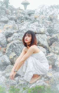 Portrait of young woman sitting outdoors