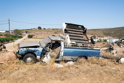 Wrecked and abandoned cars and ships in a remore location in the island