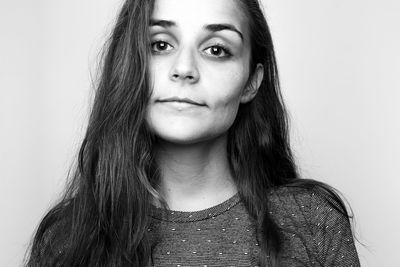 Close-up portrait of a beautiful young woman over white background