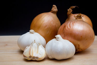 Close-up of pumpkins on table against black background