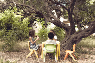 Rear view of couple sitting on chair