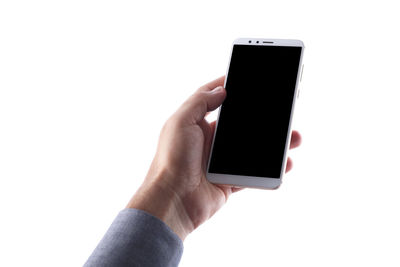 Close-up of hand holding smart phone over white background
