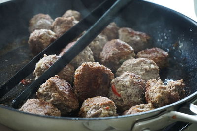 Close-up of meatballs in cooking pan