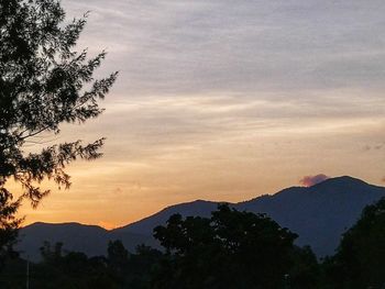 Scenic view of silhouette mountains against sky at sunset