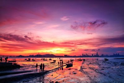 Scenic view of beach against dramatic sky