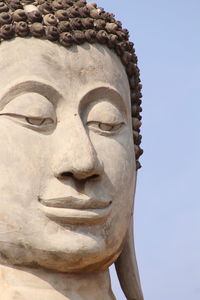 Low angle view of statue of buddha against clear sky