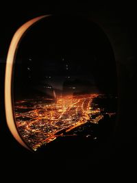 Close-up of illuminated lamp against sky at night