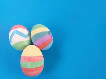 High angle view of multi colored balls against blue background