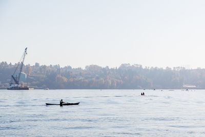 Sailboats in sea against clear sky