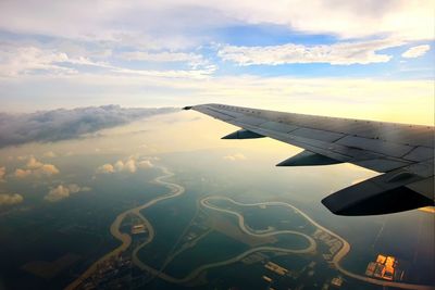 Aerial view of airplane wing against sky