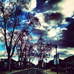 Empty road against cloudy sky