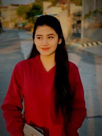 Portrait of beautiful young woman standing outdoors