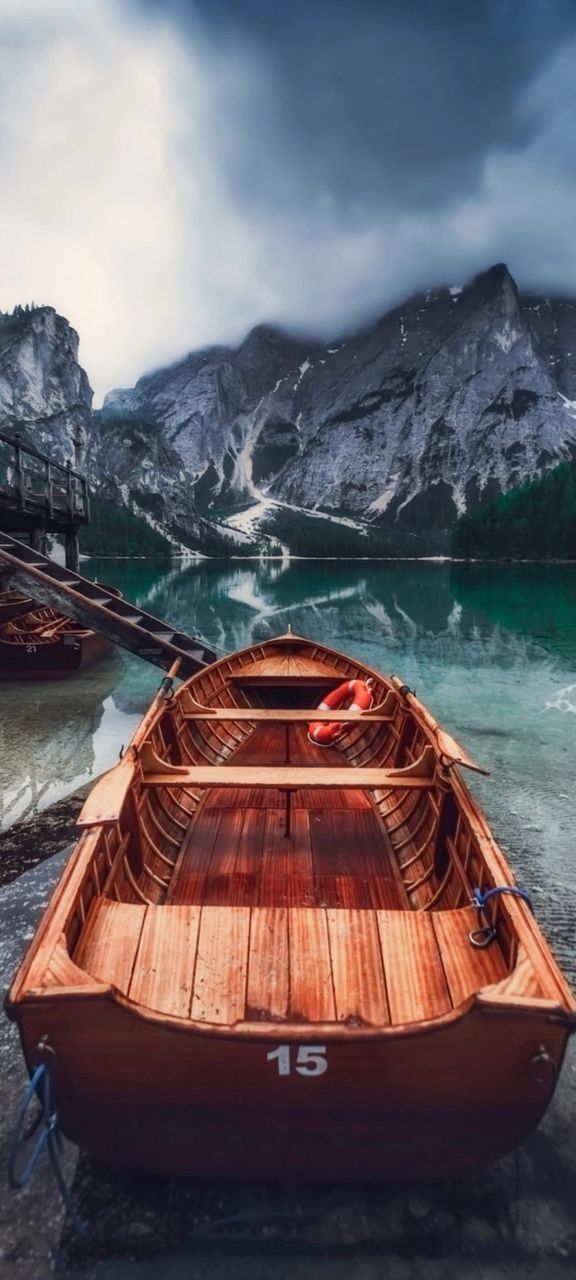 mountain, water, boat, snow, nautical vessel, vehicle, nature, cold temperature, sea, sky, transportation, scenics - nature, cloud, winter, environment, mountain range, beauty in nature, travel, travel destinations, landscape, mode of transportation, watercraft, no people, reflection, land, outdoors, tranquility, snowcapped mountain, ice, tourism, tranquil scene, adventure