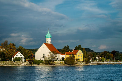 Mosque by sea against sky