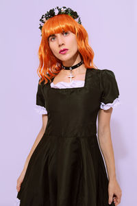 Girl in gothic style. trend accessories choker and hand band. black retro dress. autumn look