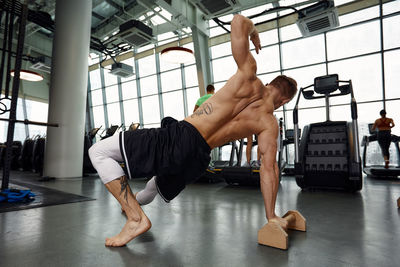 Low section of woman exercising in gym