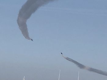 Low angle view of airplane flying against sky