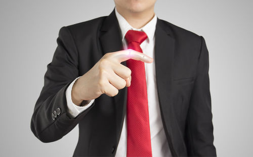 Midsection of man wearing hat against white background