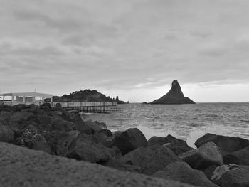 Rocks on beach against sky