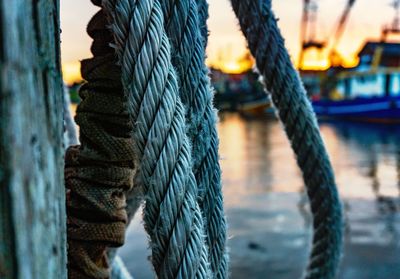 Close-up of rope at harbor against sky during sunset