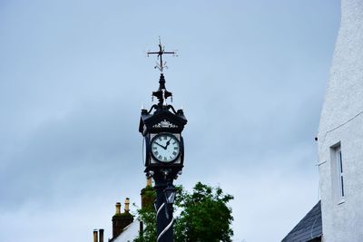 High section of clock tower against clear sky