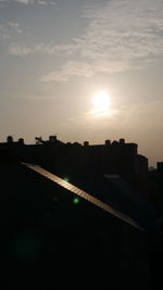 Silhouette buildings against sky during sunset