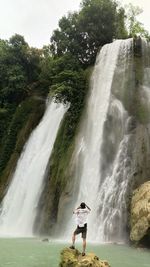 Full length of man surfing on waterfall