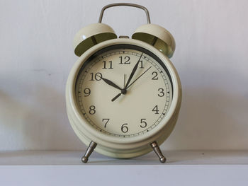 Close-up of clock on table