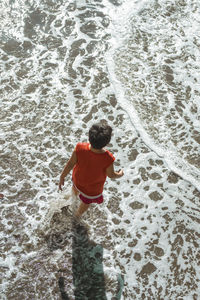 Rear view of boy at beach