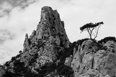 Low angle view of rock formation against sky