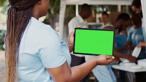 Midsection of woman using digital tablet