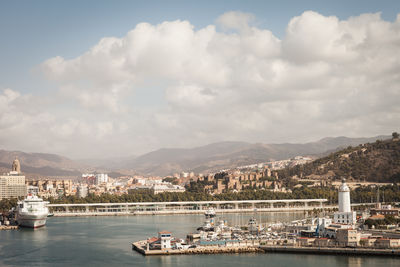 Boats moored at harbor in city