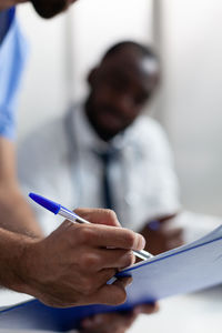 Midsection of man working at clinic