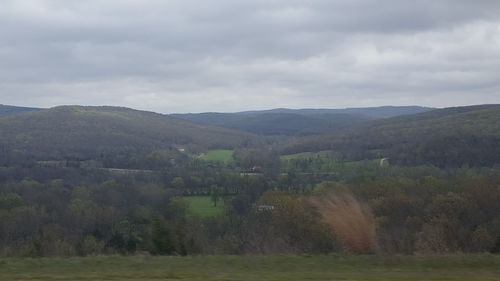 Scenic view of mountains against cloudy sky