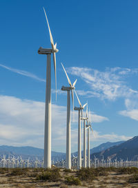 Windmill on field against sky