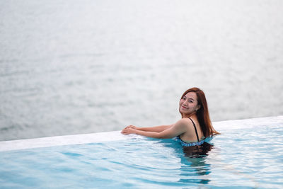 Young woman swimming in sea