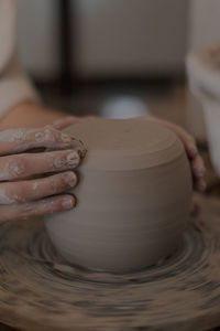 Midsection of woman making pot