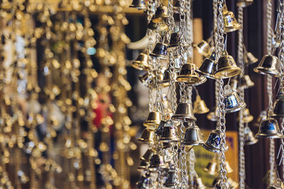 Close-up of bells hanging for sale in market