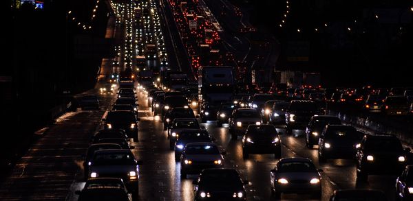 High angle view of traffic on road amidst buildings at night