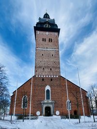 Low angle view of building against sky during winter