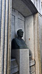 Statue of buddha against wall in building