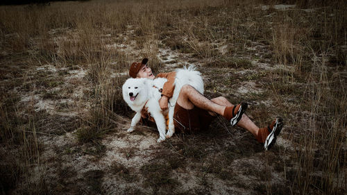 High angle view of man with dog on field